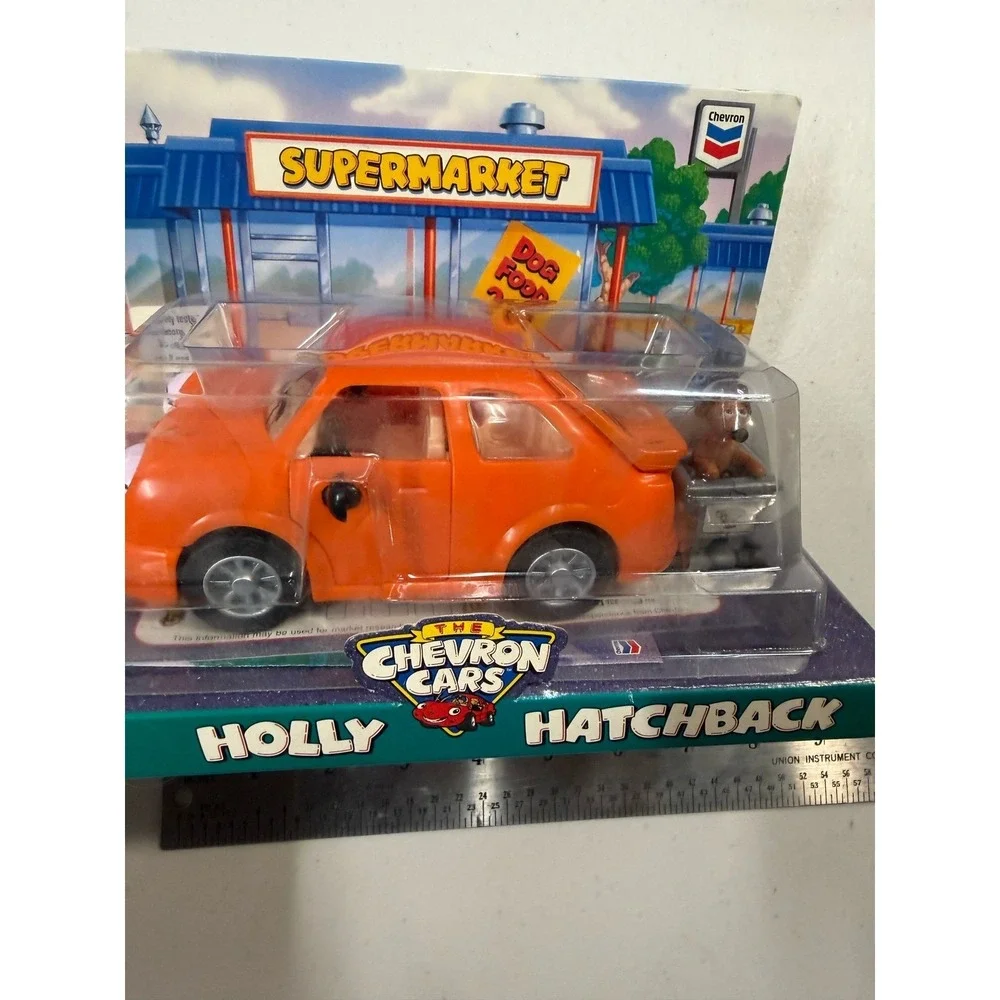 The Chevron Cars Holly Hatchback Orange Toy Car with Dog and Shopping Cart 1997